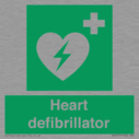 green-background-with-white-text-and-heart-defibrillator-symbol--white-cross-and~